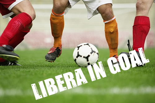Soccer Player Dribbling Between Defenders